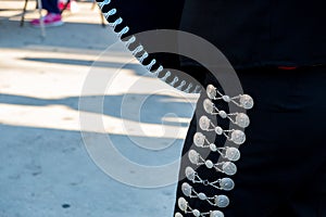 Detail of mariachi pants with ornaments while playing on a stage