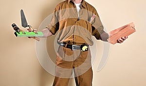 Detail of mason with tools in hands  brown background