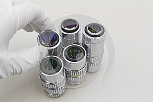 Detail of microscope lens on an white background.Closeup of microscope objectives.