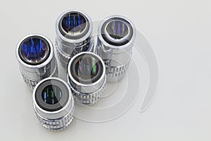 Detail of microscope lens on an white background.Closeup of microscope objectives.