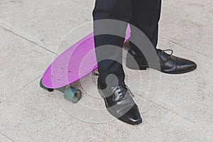 Detail of a model posing with his skateboard