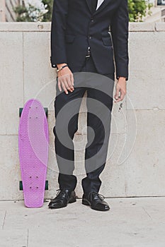 Detail of a model posing with his skateboard