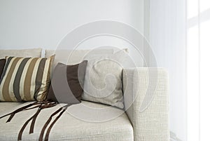 Detail of a modern beige sofa with cushions