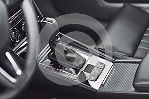 Detail of modern car interior, gear stick, automatic transmission in expensive car.