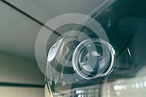 Modern car projector headlight, shallow depth of field, filter effect