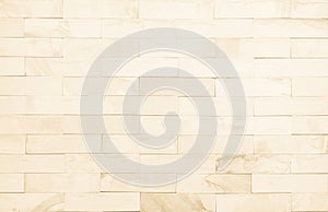 Detail of modern cream brick wall background photo. Brown light brick wall texture background for stone tile block painted in