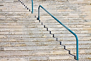 Detail of a modern curved stone staircase with metal bannister photo