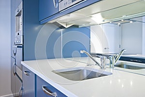 Detail of a modern kitchen in metalic blue