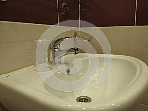 Detail of modern kitchen -sink and wooden wallpaper