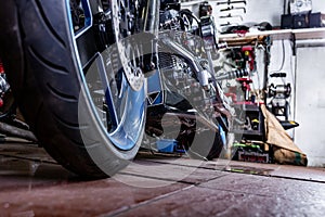 Detail on a modern motorcycle in the workshope. Motorcycle Exhaust. selective focus photo
