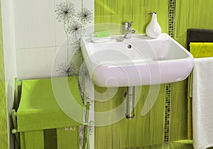 Detail of modern private bathroom interior in green with sink