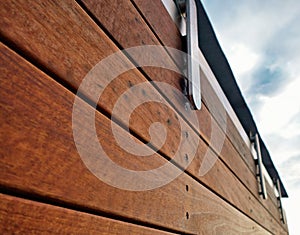 Detail of a modern wood and stainless fence.