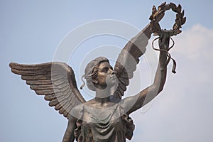 Detail of monument to goddess of victory Nike against the sky.