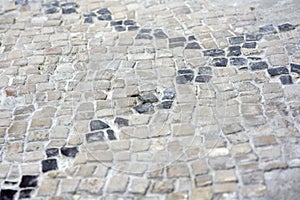 Detail of a mosaic floor. A black cross on a white background