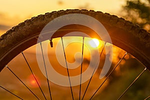 Detail of a mountain bike wheel at sunset. Close-up of bicycle tire. Enduro, downhill, cross country. Space for Text.