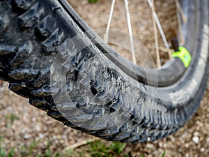 Detail of a mountain bike wheel and tire with blurred background
