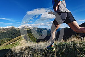 Detail of mountain runner legs during a downhill workout