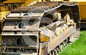 Detail of muddy caterpillar tracks on bulldozer.