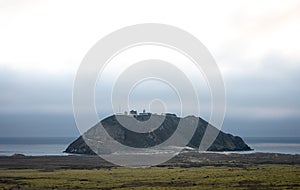 Detail of a mysterious island with a house in the fog on the west coast of the United States