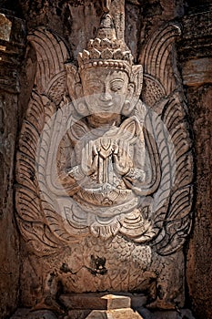Detail of a nat statue angel of spirit in Tharkhaung buddhist monastery near Inle lake in Burma Myanmar photo