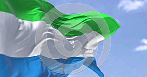 Detail of the national flag of Sierra Leone waving in the wind on a clear day