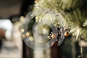 Detail of New Year decoration, Christmas tree with toys on the street during the day.