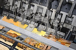 Detail of offset print book stitching machine