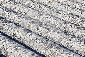 Detail of an old aged dangerous roof made of corrugated asbestos panels - one of the most dangerous materials in buildings and