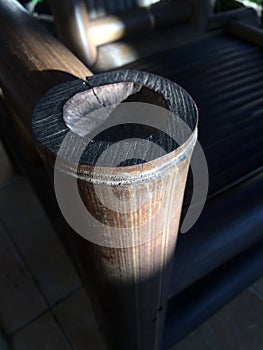 Detail of an old bamboo chair in the sunshine. Empty bamboo chair or kursi bambu. Close up of bamboo chair photo