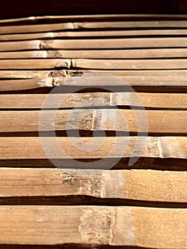 Detail of an old bamboo table in the sunshine. Empty bamboo table or meja bambu. Close up of bamboo table photo