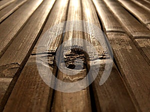 Detail of an old bamboo table in the sunshine. Empty bamboo table or meja bambu. Close up of bamboo table photo