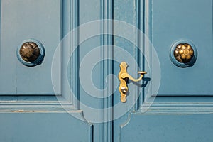 Detail of old blue door with golden doorknob in Dusseldorf, Germ