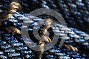 Detail of old blue jeans with seams in contrast color