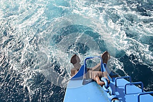 Detail of an old boat stern with anchor sailing in deep water