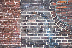 Detail from an old brick wall with different patterns visible