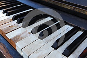 Detail of old, broken and dusty piano claviature photo