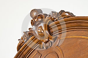 Detail of an old carved italian wooden furniture with floral elements just restored