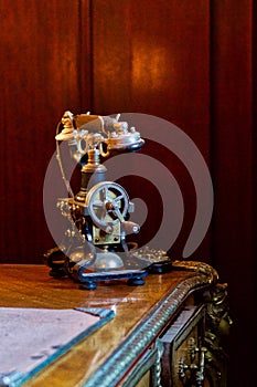 Retro style antique telephone, on a stylish old desk