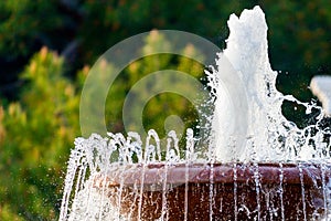 Detail of an old classic style stone fountain with flowing water