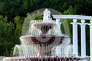 Detail of an old classic style stone fountain with flowing water