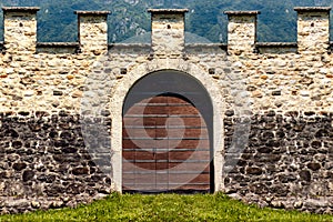 Detail of an old door and a castle boundary wall