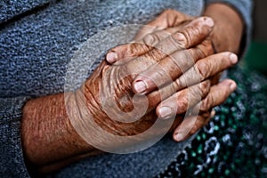 Detail on old hands of senior wrinkled woman