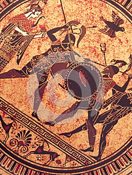 Detail from an old historical greek paint over a dish. Mythical heroes and gods fighting on it photo