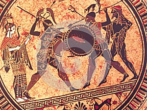 Detail from an old historical greek paint over a dish. Mythical heroes and gods fighting on it photo