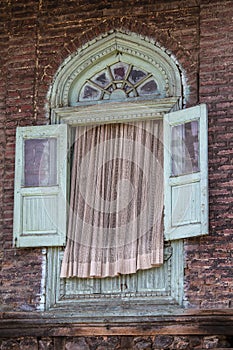 Detail of an old house with window and tulle is located in downtown area in Srinagar, Jammu and Kashmir state, India