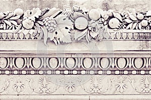 Detail of an old Italian molding stone eaves with flowers and fr