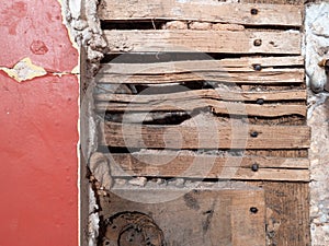 Detail of old lath and plaster wall in abandoned derelict building.