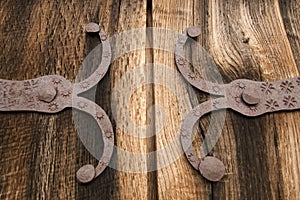 Detail of old oak wood gate with metal decoration