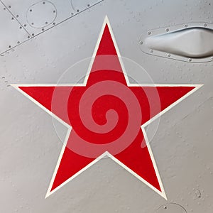 Detail of an old Russian jet fighter with a red star painted on