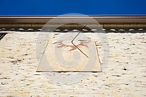 Detail of old sundial on a sunny day in a mediterranean country